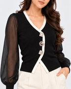 Close-up of jewel button and neckline detail