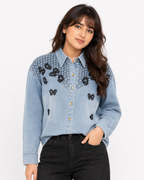 Close-up front view of butterfly embroidered denim shirt